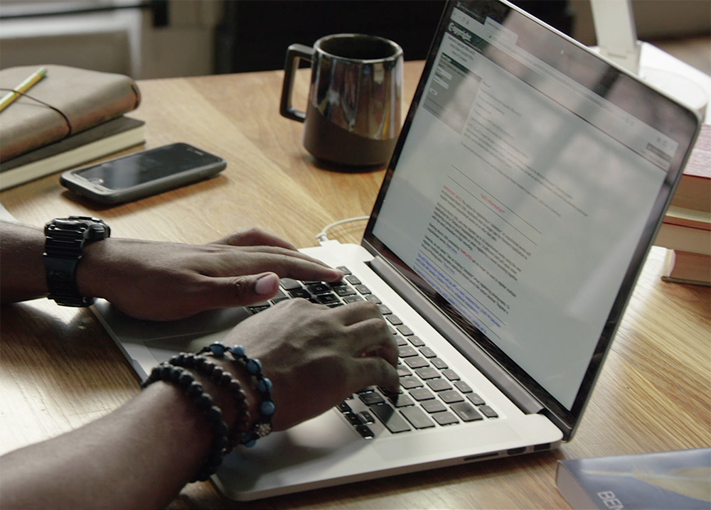 Person typing on laptop, registering